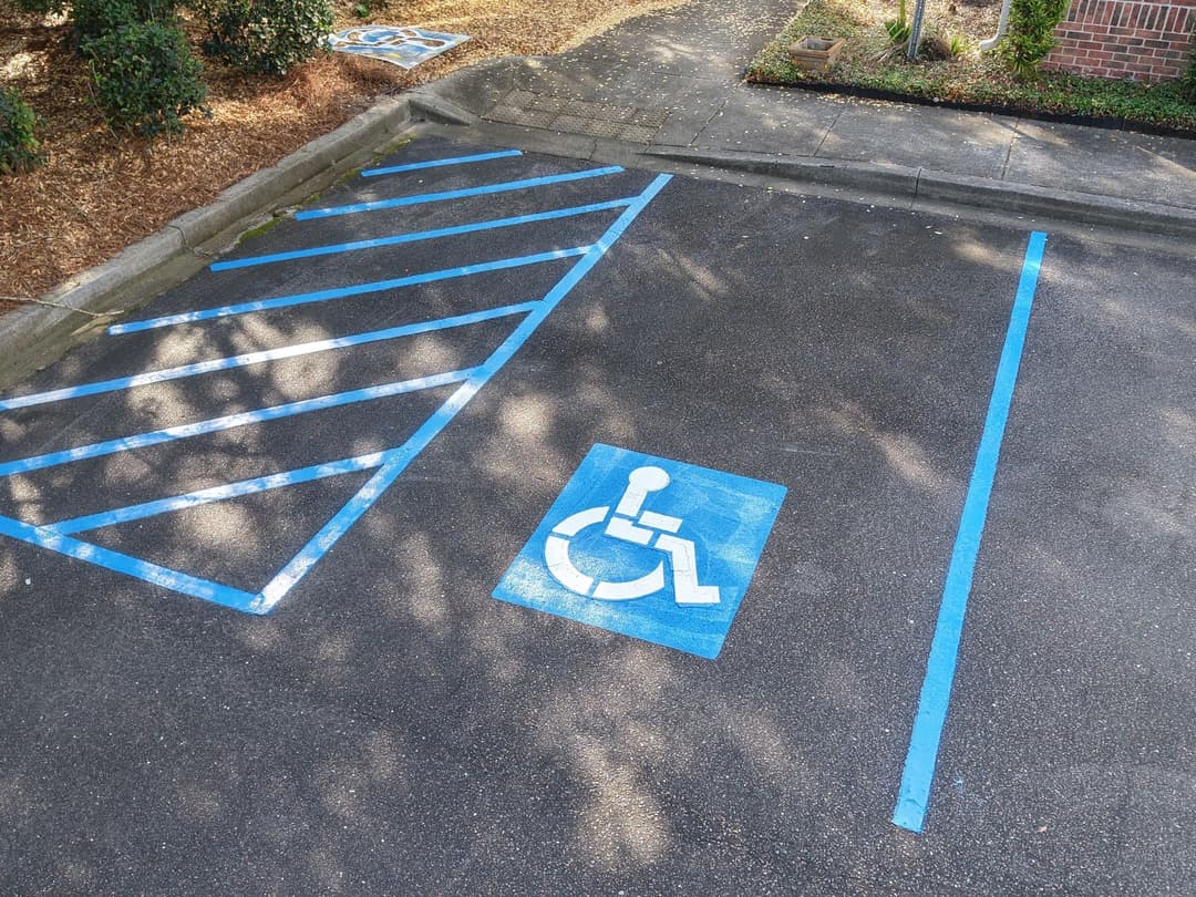 Accessible parking space with clearly marked blue lines and wheelchair symbol.