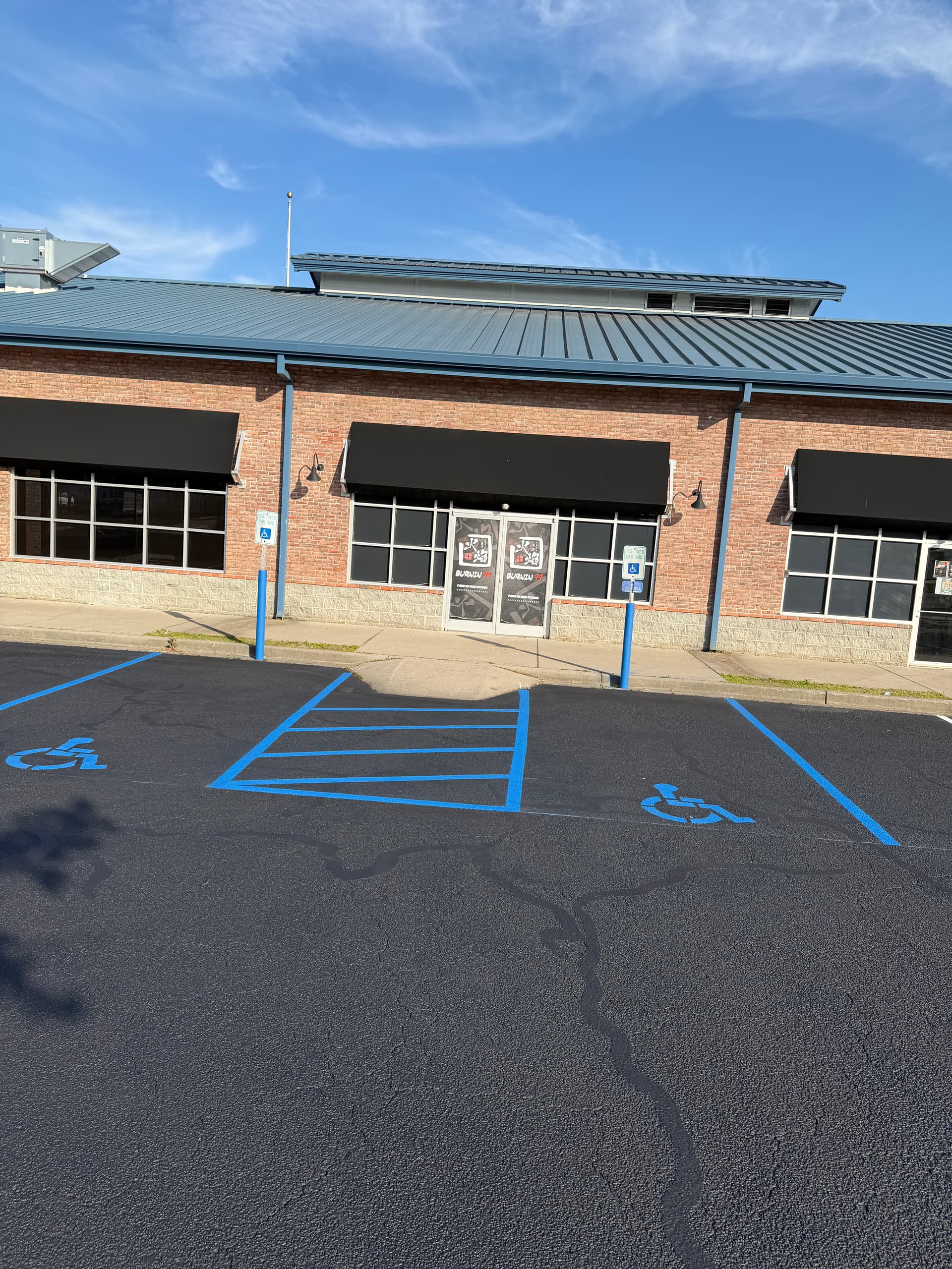 Shopping Center Parking Lot Gets Full Crack Fill, Seal, and Stripe image